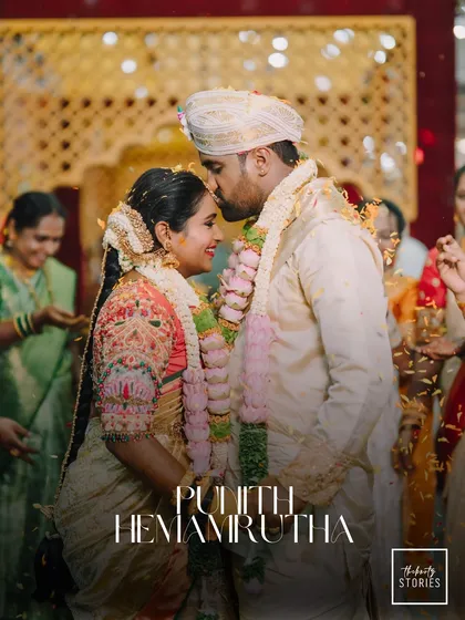 A moment of blessing and love during the wedding ceremony. The groom's tender kiss on his bride's forehead, surrounded by the warmth of the rituals, makes for an unforgettable memory.