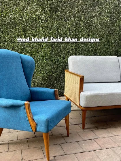 A close-up of one of the blue wingback chairs.