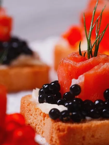 An elegant canapé of smoked salmon rosette and fine black caviar on a crisp toast point. This bite-sized appetizer showcases our flair for gourmet presentation and the use of premium ingredients, perfect for a luxury high tea or cocktail party.