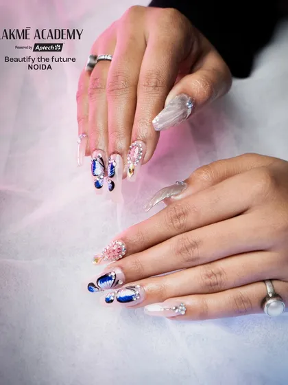 Another angle of the butterfly nail art, showing how the design flows across multiple nails. We teach composition and layout to ensure your nail art tells a cohesive visual story.