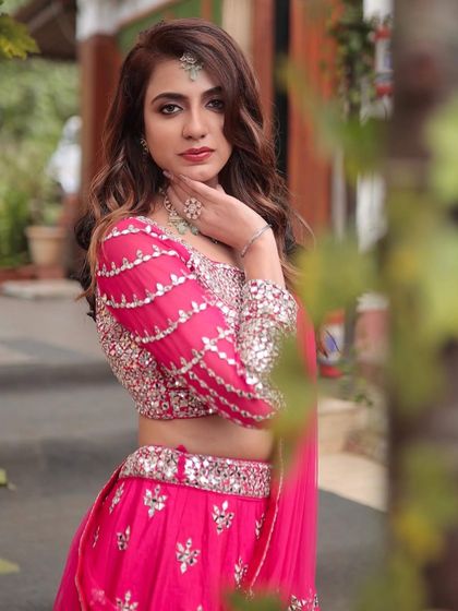 A stunning portrait of the bride-to-be. The makeup is glamorous yet sophisticated, perfect for a modern engagement party.