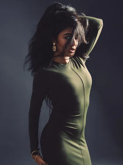A mysterious and moody shot. The hair obscuring the face creates intrigue and focuses attention on the form and silhouette.