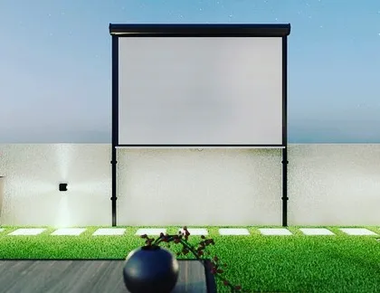 Imagine watching your favorite movies under the stars. This is a design concept for an outdoor movie night setup on a terrace, complete with an all-weather projector screen, comfortable seating, and ambient lighting.