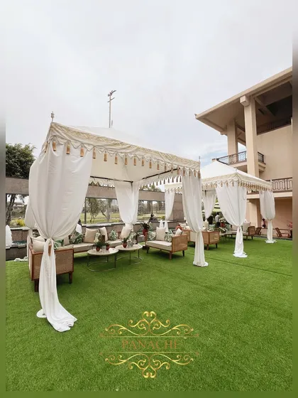 Elegant white cabanas with cozy cane seating, creating a luxurious and comfortable lounge area for guests.