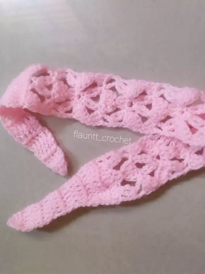 Another view of the pink lacy headband, showing its tapered ends which make for a comfortable fit.