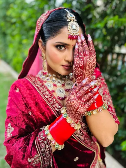 The final look. Here you can see how the deep, rich stain of the mehndi beautifully complements the bride's entire wedding attire, completing her stunning look on the big day.