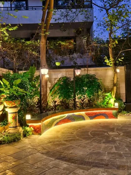 We transform simple backyards into serene sanctuaries. This space was designed for quiet evenings and peaceful moments, featuring a custom mosaic bench, a calming Buddha water feature, and strategic lighting that creates a magical ambiance after sunset.