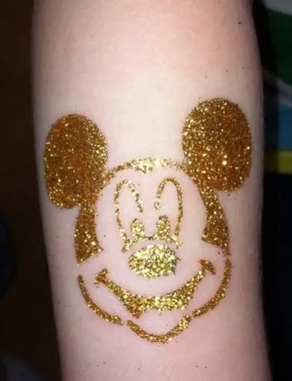 The iconic Mickey Mouse head in sparkling gold glitter. This classic character design is a fun and recognizable choice for Disney fans of all ages.