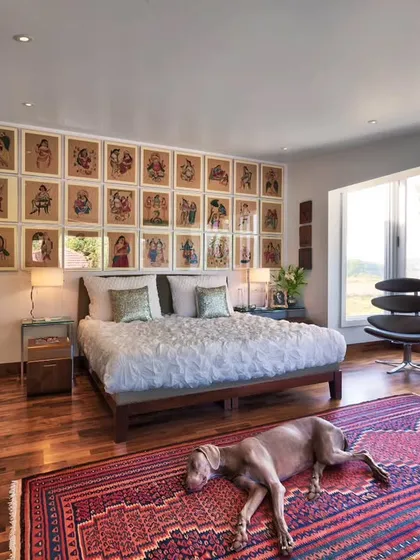 In the Aishbagh holiday home, a bedroom becomes a personal sanctuary with a view of Damdama Lake. We believe in spaces that connect with their surroundings, using natural light, art like these Kalighat paintings, and rich textiles like the Kurdish kilim to create a sense of place and peaceful retreat.
