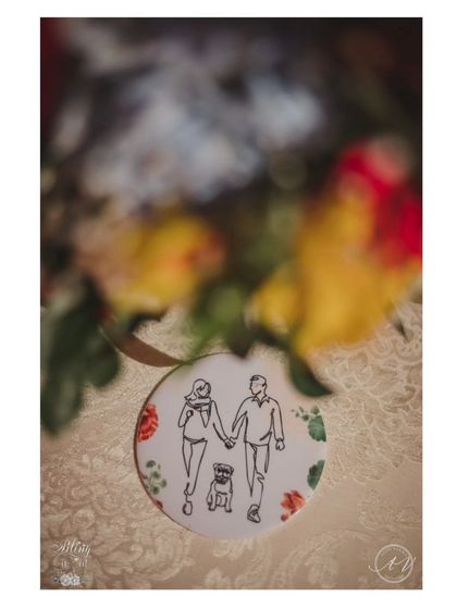 A close-up of the custom illustrated coaster, placed within a floral setting, highlighting the blend of personal touches and beautiful decor.