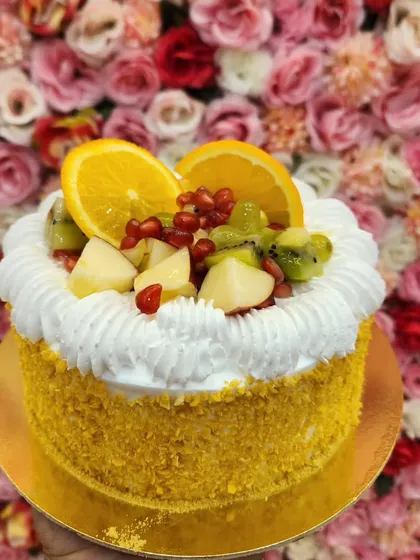 My Fresh Fruit Cake is a celebration of seasonal flavors. It's topped with a colorful assortment of fresh fruits like oranges, kiwis, and pomegranates, all resting on a bed of light whipped cream. It's as refreshing as it is beautiful.
