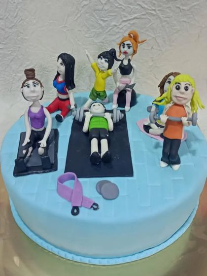 A fun and detailed fitness-themed cake showing a whole group of people working out at the gym. This cake is perfect for a gym owner, trainer, or a group of fitness friends.