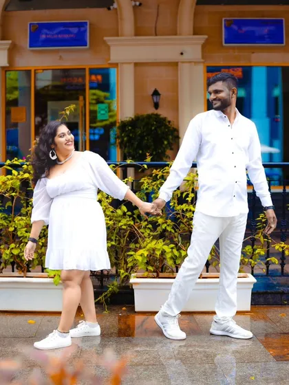A simple and sweet photo of the couple holding hands, dressed in all white. This creates a clean, fresh, and modern look.
