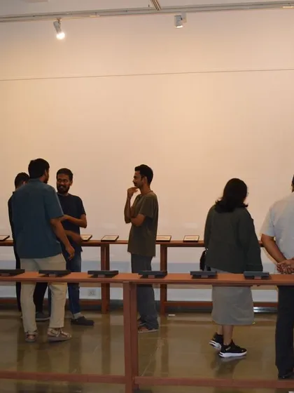 Visitors studying the reverse paintings on display.