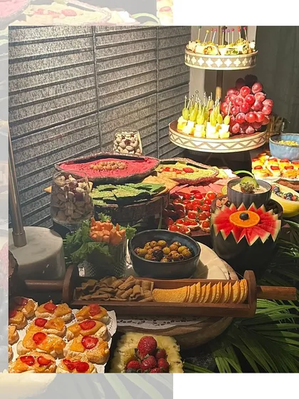 A closer look at the variety on our grazing tables. Here you can see carved watermelon, fresh bruschetta, cheese platters, and fruit skewers, offering a delightful mix of fresh, savory, and sweet options.