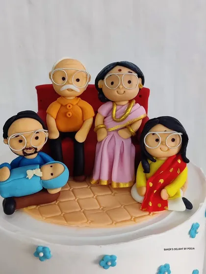 A close-up of the incredibly detailed, hand-sculpted fondant family, capturing the likeness and love of four family members across three generations.