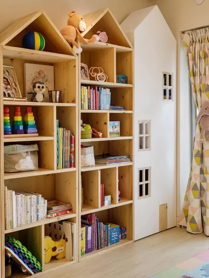 Let's make reading fun! I designed these house-shaped bookshelves to create a mini library for a child's room. They are handmade from natural wood and provide plenty of space for all their favorite stories and treasures.