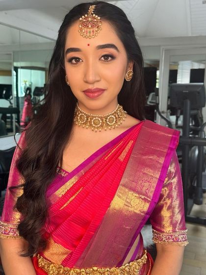 The complete look for the Ganesh Pooja, with a classic half-up hairstyle and radiant makeup.