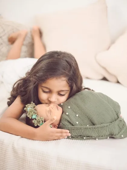 The sweet, gentle bond between a big sister and her new baby sibling. These are the quiet, precious moments we aim to freeze in time during our newborn and sibling photoshoots.