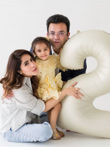 A loving family portrait from a second birthday session. The family huddles together, creating a warm and intimate memory.