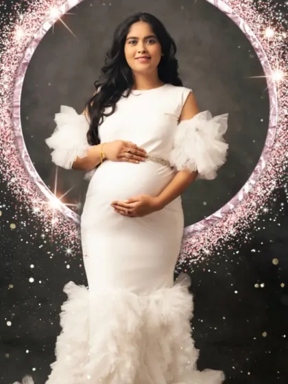 A glamorous shot in our white mermaid gown with ruffled off-the-shoulder sleeves, set against a sparkling backdrop.