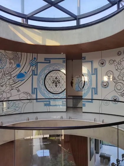 A panoramic view of our mural reimagining the creator, preserver, and destroyer for a family's holiday home. The artwork wraps around a circular atrium, blending spiritual iconography with cosmic elements.