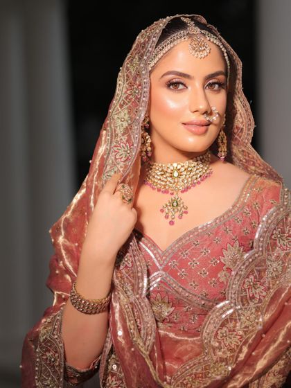 A classic bridal portrait. The styling focuses on the heavy choker and the traditional nath, key pieces for a heritage bridal look.