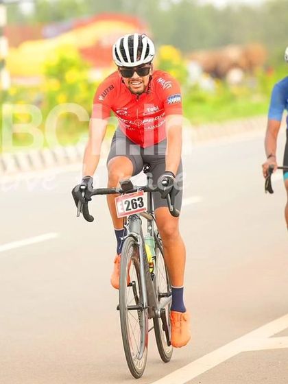 An amateur rider, smiling as he races.