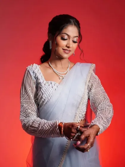 A more posed shot showing the details of her makeup and jewelry. The soft eyeshadow and defined lashes make her eyes pop.