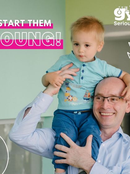 A father holds his young son on his shoulders, showcasing the strong bond that our programs help to foster. We believe starting an active lifestyle young sets the foundation for a lifetime of health.
