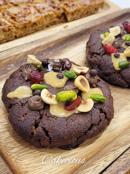 Another look at my dark chocolate overload cookies on a wooden board. They are as delicious as they look.