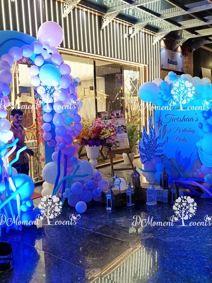 The full entrance setup for the mermaid party, including a welcome sign and themed decor, all glowing under cool blue lights.