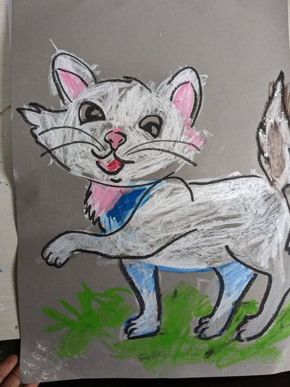 A charming cat illustration made with oil pastels on grey paper. This project helps young students understand how to make colors pop on a toned background.
