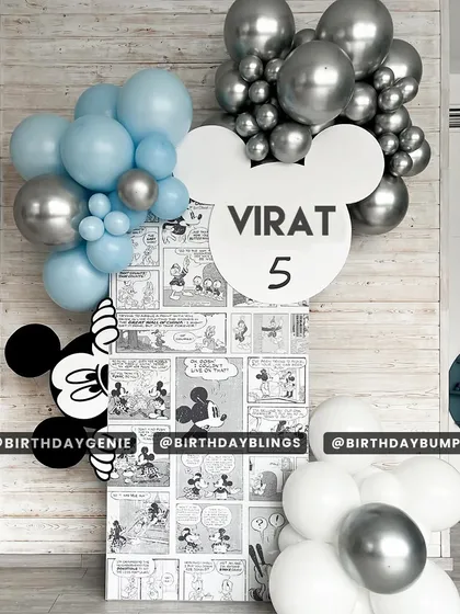 A unique take on the Mickey Mouse theme, using a comic-strip backdrop and a blue and silver color palette. The Mickey-ear-shaped name sign is a fun, custom touch.