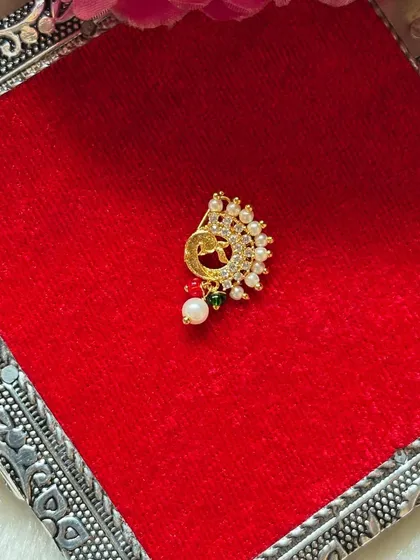 A small and delicate clip-on Nath with pearls and a hint of green. This is a great option for a simple, understated traditional look.