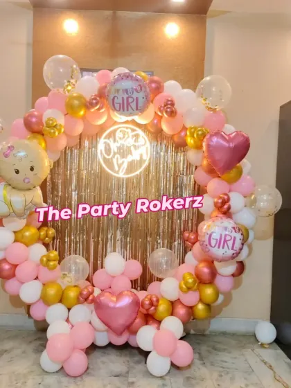 Another angle of the welcome baby girl decoration, showing the beautiful arrangement of pink, white, and chrome gold balloons.