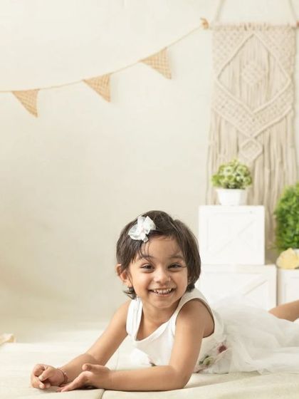 My boho-themed sessions use natural textures like macrame, wood, and greenery to create a calm and earthy setting that beautifully complements your child's simple joy.