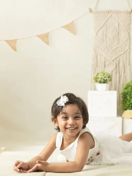 My boho-themed sessions use natural textures like macrame, wood, and greenery to create a calm and earthy setting that beautifully complements your child's simple joy.