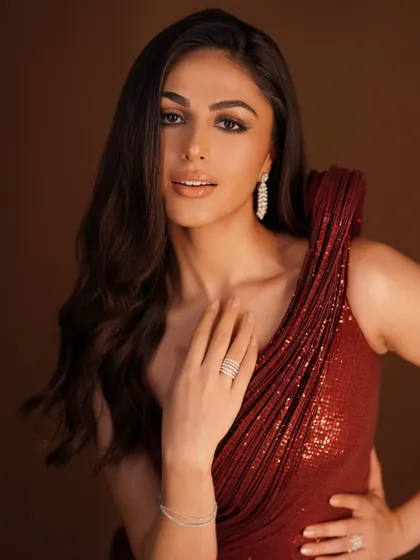 A final look at the stunning details of this red gown. The soft, romantic glow of the fabric paired with delicate diamond jewelry creates a look of pure glamour and sophistication.