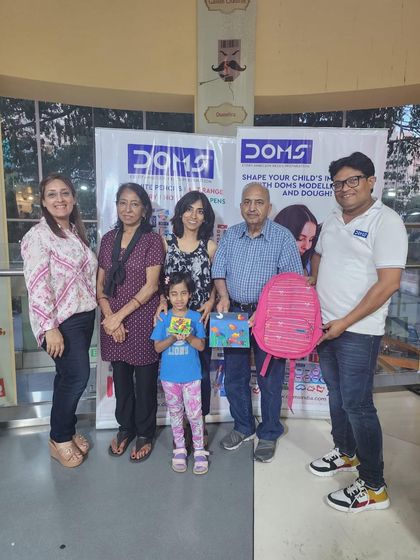 A multi-generational family poses together after a fun session of art. My workshops aim to bring families together for a shared, creative experience.