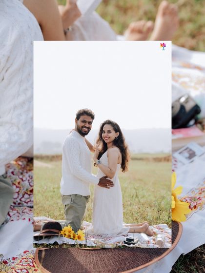 A sweet portrait taken during a picnic, framed by the cozy setup of blankets and books, making it feel personal and intimate.