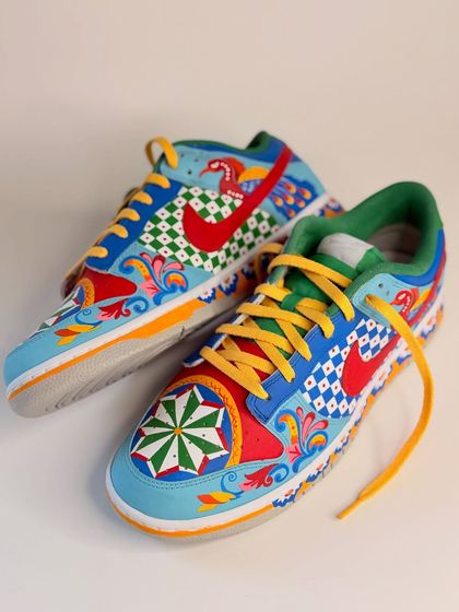 This view shows both shoes of the custom Dunks, highlighting the symmetrical yet varied design. I even painted a small bird motif into the swoosh, adding another layer of detail.