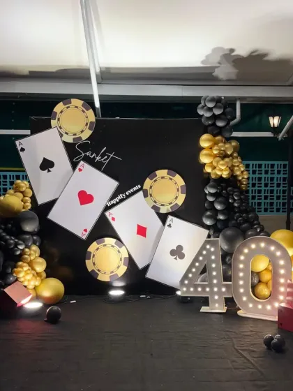 The full Casino Night backdrop, showing the dynamic arrangement of cards and the dramatic lighting that sets the mood.