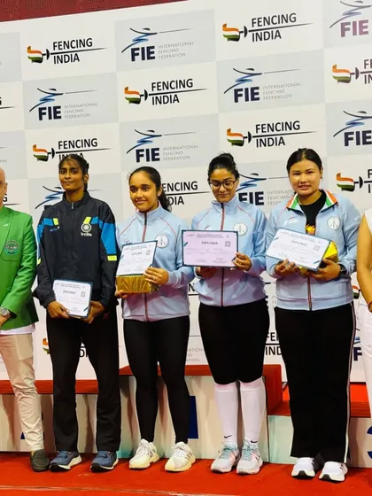 Our fencer stands on the podium at the FIE Foil Women's Satellite Tournament. Competing and placing at an international level event is a core goal of our competitive program.