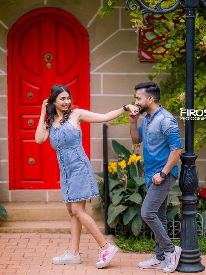 A romantic gesture in front of a bright red door on our European street set, complete with a classic lamppost.