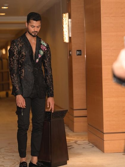 A full-length shot of the lace blazer outfit, captured in a candid, in-motion style.