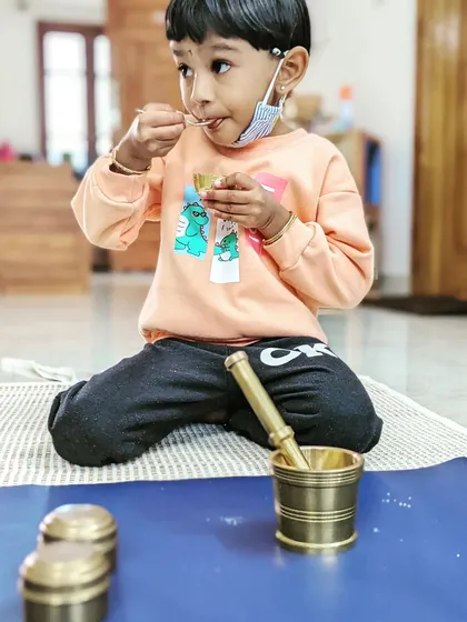 The pride of accomplishment is written all over her face. After carefully pounding her own snack, she gets to enjoy the results. This is a simple yet profound practical life activity that builds independence and confidence.