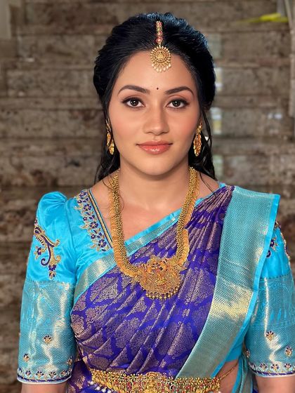 A smiling portrait that shows off the client's natural glow, enhanced by soft makeup.