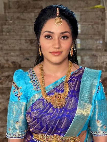 A smiling portrait that shows off the client's natural glow, enhanced by soft makeup.
