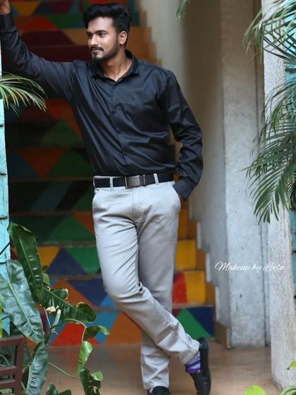 A full-length shot of a male model in a stylish setting. The grooming ensures he looks his best for this professional photoshoot.
